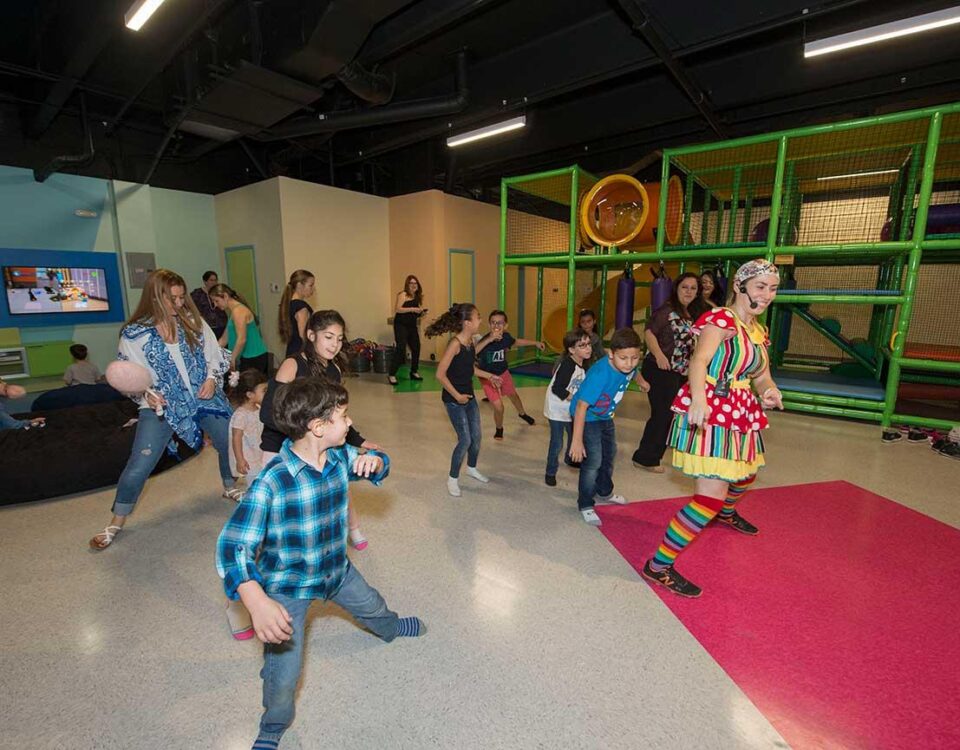 Kids dancing along to a game with a BirthdayLand staff member.