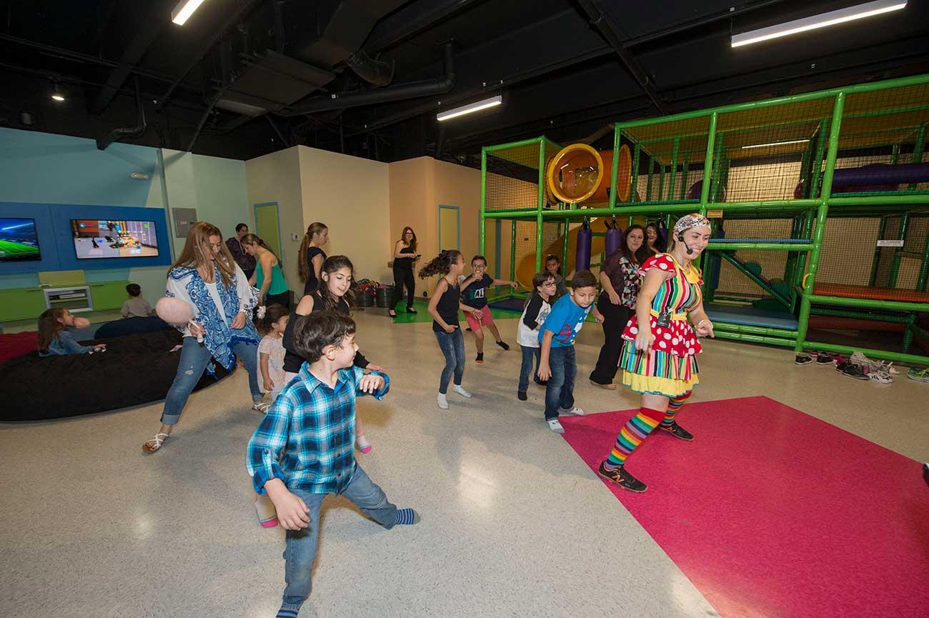 Kids dancing along to a game with a BirthdayLand staff member.