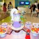 Colorful macaroons and customized cake on the table