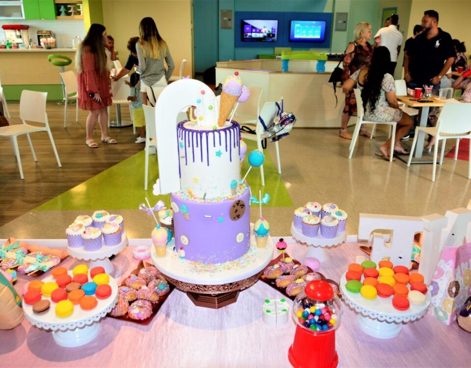 Colorful macaroons and customized cake on the table