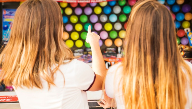 girls playing balloon shoot