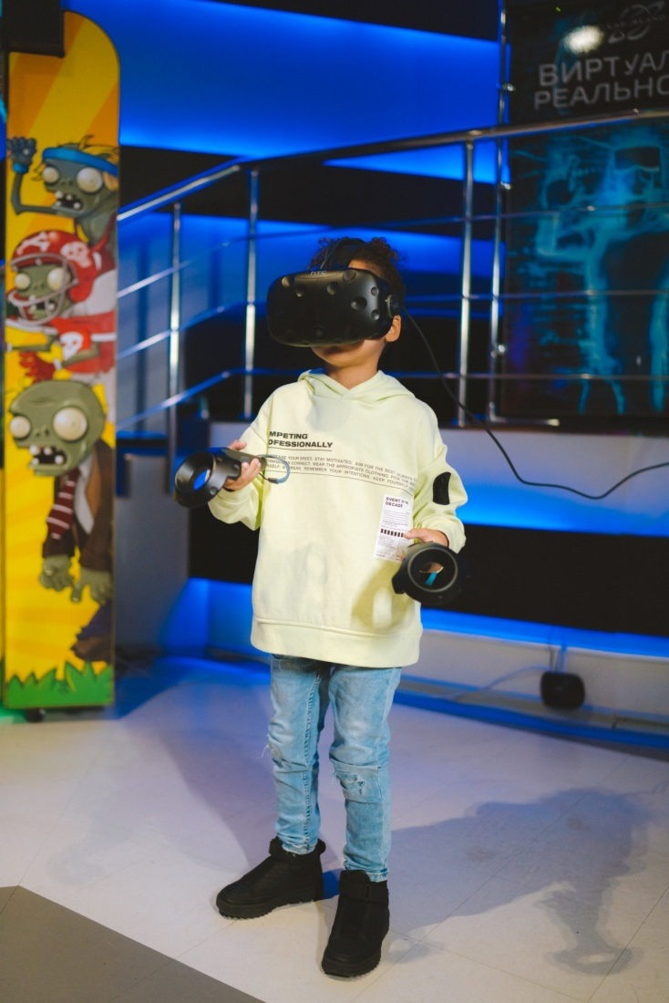 A kid playing a virtual reality game at an indoor party place