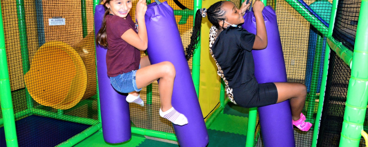 children playing at an indoor playground