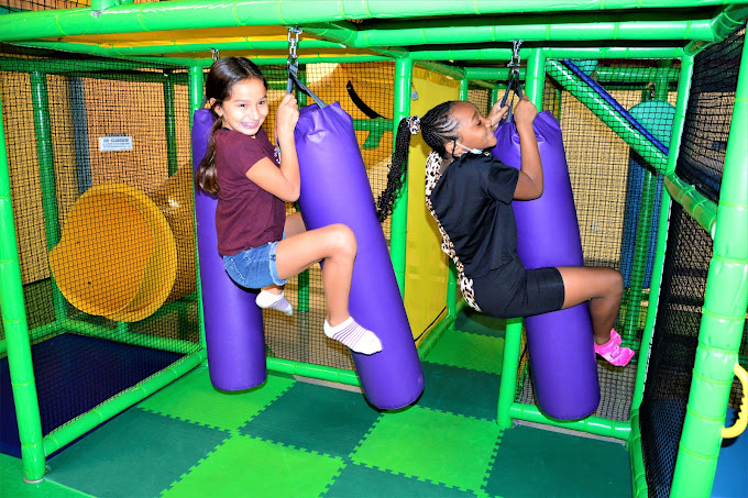 Two tween girls enjoying the indoor playground at a birthday party At BirthdayLand