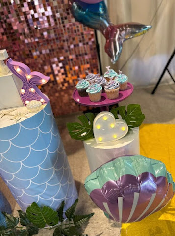 a picture of the decorations and snacks for a mermaid underwater birthday-themed party