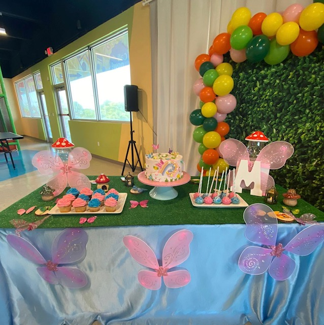 an enchanted garden birthday party table with snacks