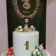 a Snow White-themed first birthday party cake