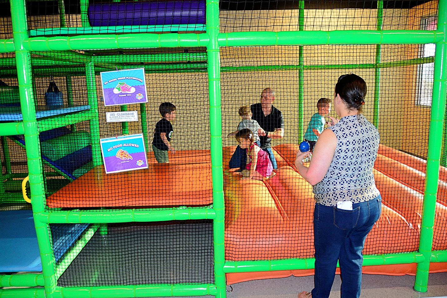 children having fun and enjoying sporty birthday party activities in an indoor playground