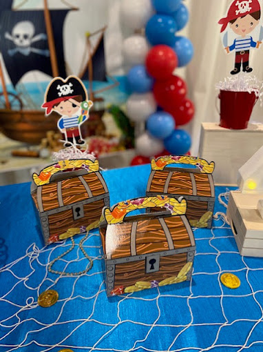 Treasure boxes décor with a pirate cut-out for kid’s party at BirthdayLand