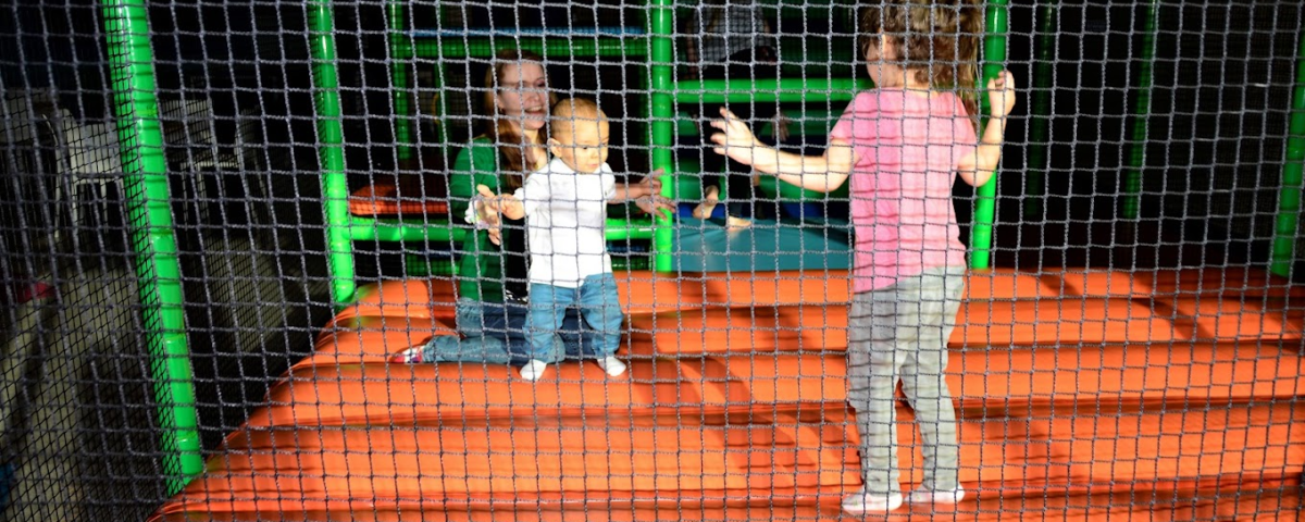 A mother with her kids inside a play area
