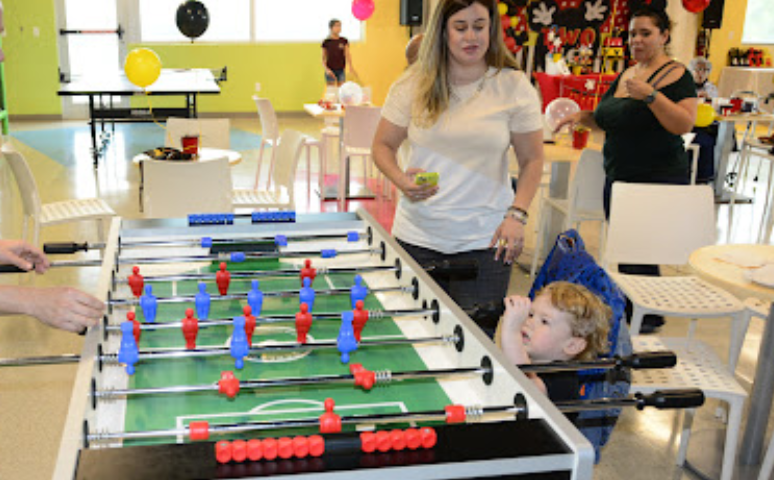 People around a foosball table