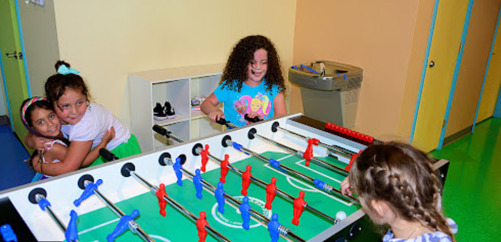 Kids playing foosball
