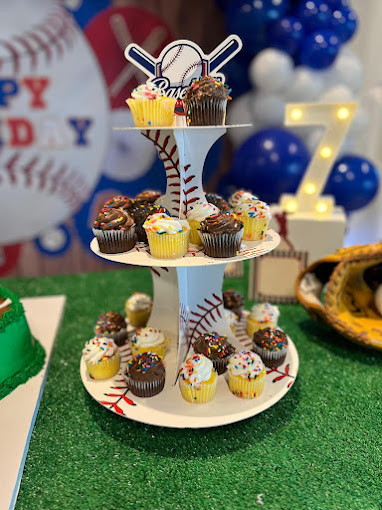 An image of birthday cupcakes on a rotating three-tier tray