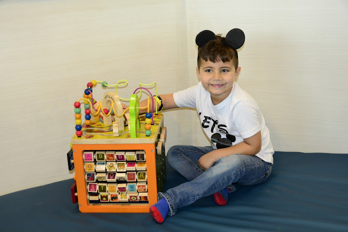 A boy playing with an educational toy at a birthday celebration at BirthdayLand 